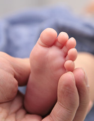 Baby foot in father hands