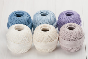 Set Of Cotton Crocheting Thread Bobbins on Wooden Table