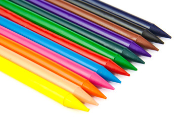 Set of colour crayons on white background.
