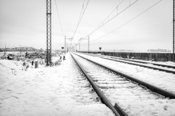 Country railroad, winter landscape with snow. BW photo