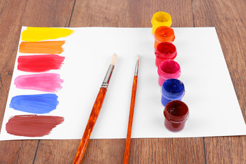 Colorful paint strokes with brush and paint cans