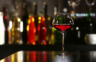 Glass of wine with bar on background