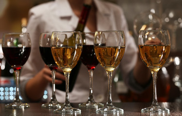Bartender working at counter on bar background