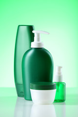 Cosmetic bottles on bright background