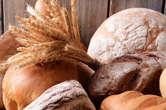 Different bread on table on wooden background