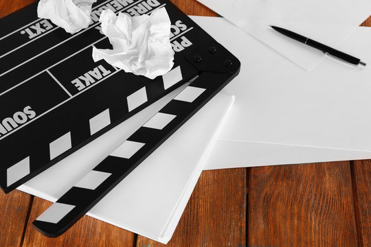 Moving clapper with sheets of paper and pen