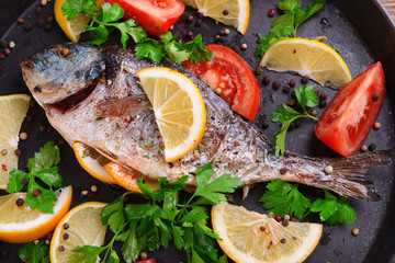Fototapeta na wymiar Tasty baked fish on table close-up