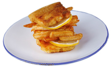 Breaded fried fish fillet and potatoes with sliced lemon