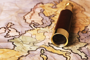 Spyglass on world map background