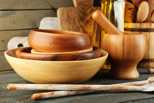Wooden kitchen utensils with glass bottle of olive oil