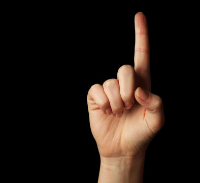 Female hand gesture on black background