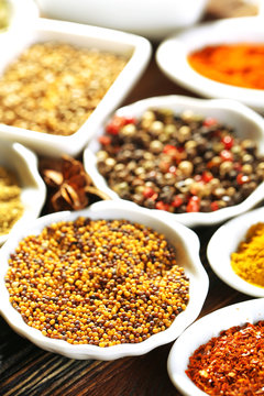Different kinds of spices in ceramics spoons, close-up,