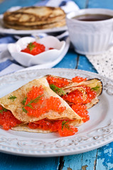 A stack of pancakes with red caviar