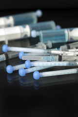 blue oral syringes on black backgoround