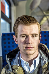 cool boy with red hair in a train