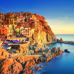 Manarola village, rocks and sea at sunset. Cinque Terre, Italy