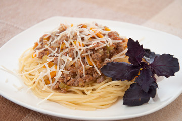 Spaghetti bolognese with cheese and basil