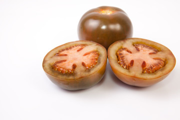 Whole and sliced kumato tomatoes