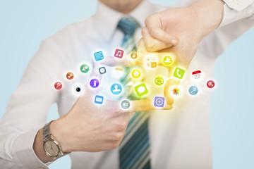 Hands creating a form with mobile app icons