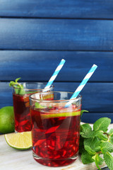Pomegranate drink in glasses with slices of lime and mint