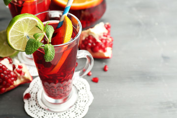 Pomegranate drink in glasses with mint and slices of orange and