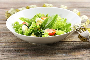 Salad with quail egg and basil in plate