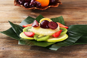 Fruit dessert on green leaf on table