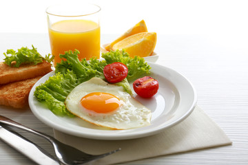 Bacon and eggs on color wooden table background