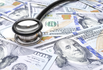 Stethoscope on us dollar bills.