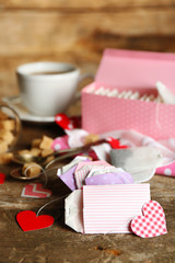 Heart shaped teabag tags and box on wooden background