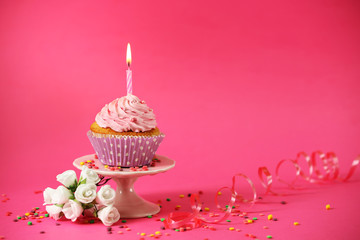 Delicious cupcake on table on pink background