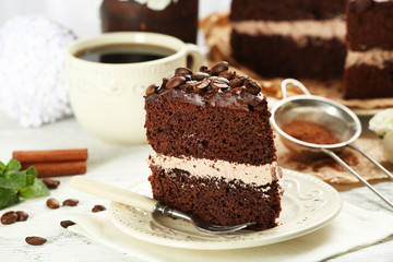 Delicious chocolate cake on table on brown background