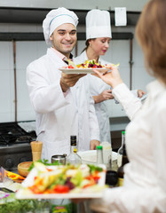 Chefs and young waiter