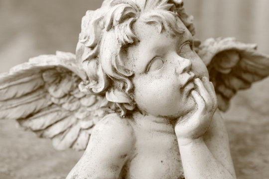 image  of cherub figurine in sepia