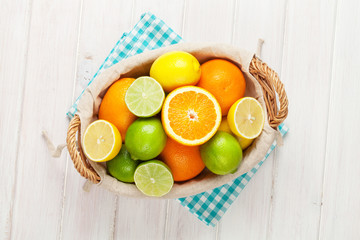 Citrus fruits in basket. Oranges, limes and lemons