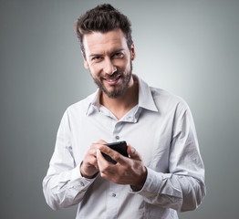 Smiling businessman with smartphone