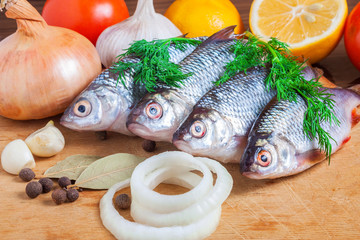 Fresh fish and vegetables on a cutting board