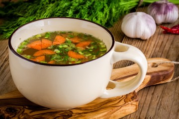 vegetable soup in a cup on a wooden background