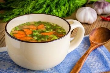 vegetable soup in a cup on a wooden background
