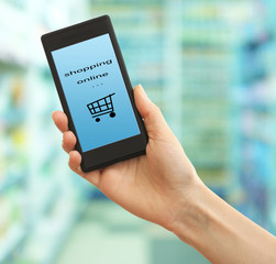 Mobile shopping concept. Hand holding mobile phone for internet