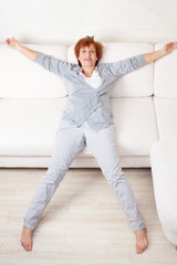 Happy mature woman on sofa