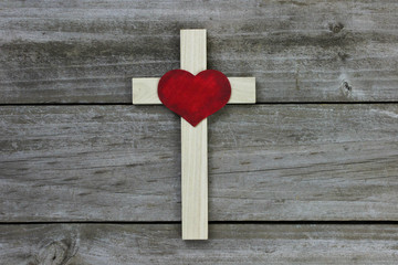Wooden cross with heart hanging on wood background