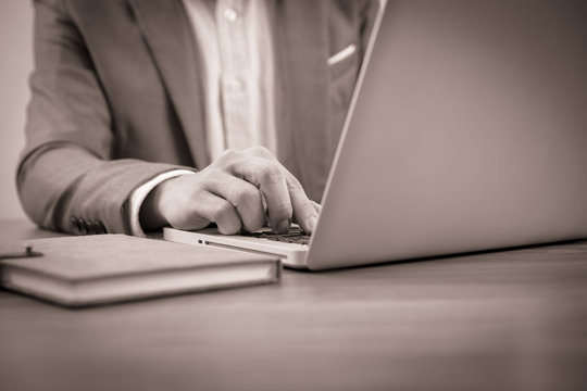 Hands of a man working with laptop