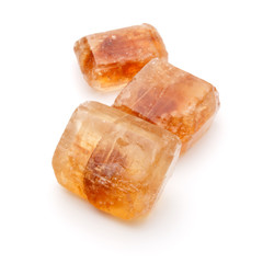 Brown caramelized lump cane sugar cube isolated on white backgro