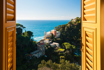 View of the hills surrounding Portofino seen through a window