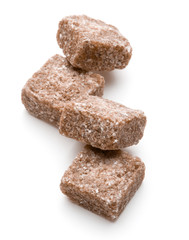 Brown lump cane sugar cube isolated on white background cutout