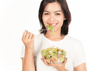 Pretty girl eating fresh vegetable salad