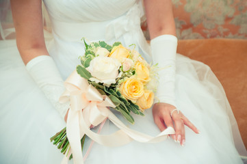 Wedding bouquet in hands of the bride