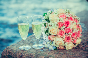 glass of champagne and a bouquet of the bride