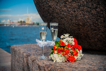 glass of champagne and a bouquet of the bride